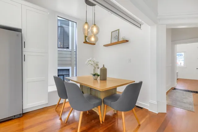 a view of a dining room with furniture and wooden floor
