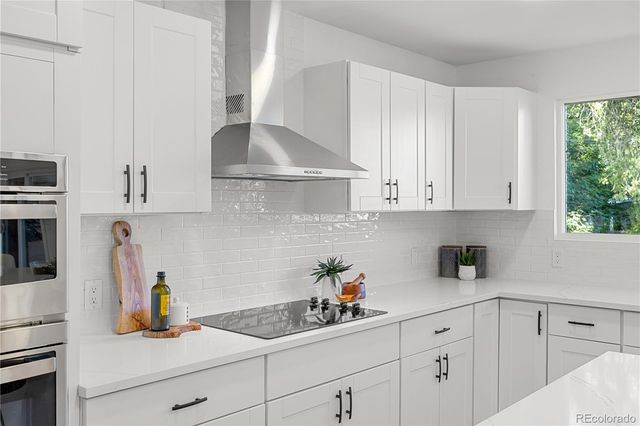 a view of a hallway with wooden floor and dining room