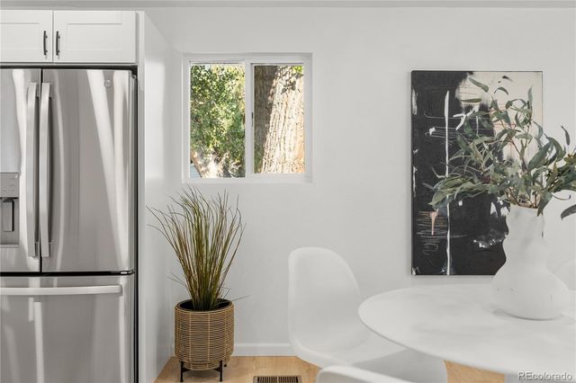 a bedroom with bed and a potted plant