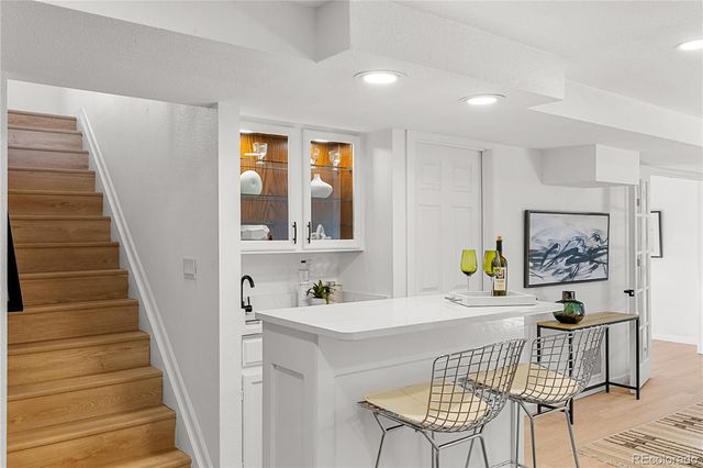 a view of a house with backyard and trees