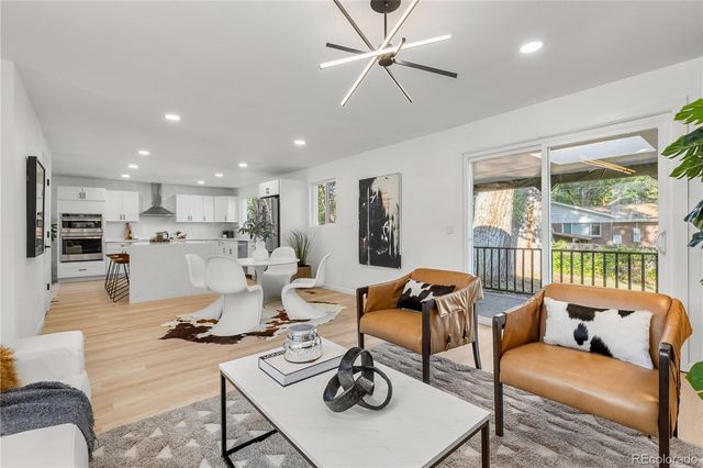 a living room with furniture and kitchen view
