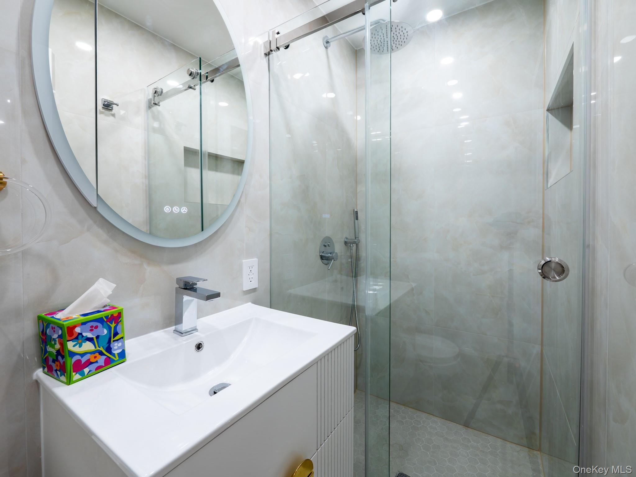 139-15 83rd Avenue, Unit 423 Queens, NY 11435 - Photo 14 of 24 Bathroom with vanity and a shower stall
