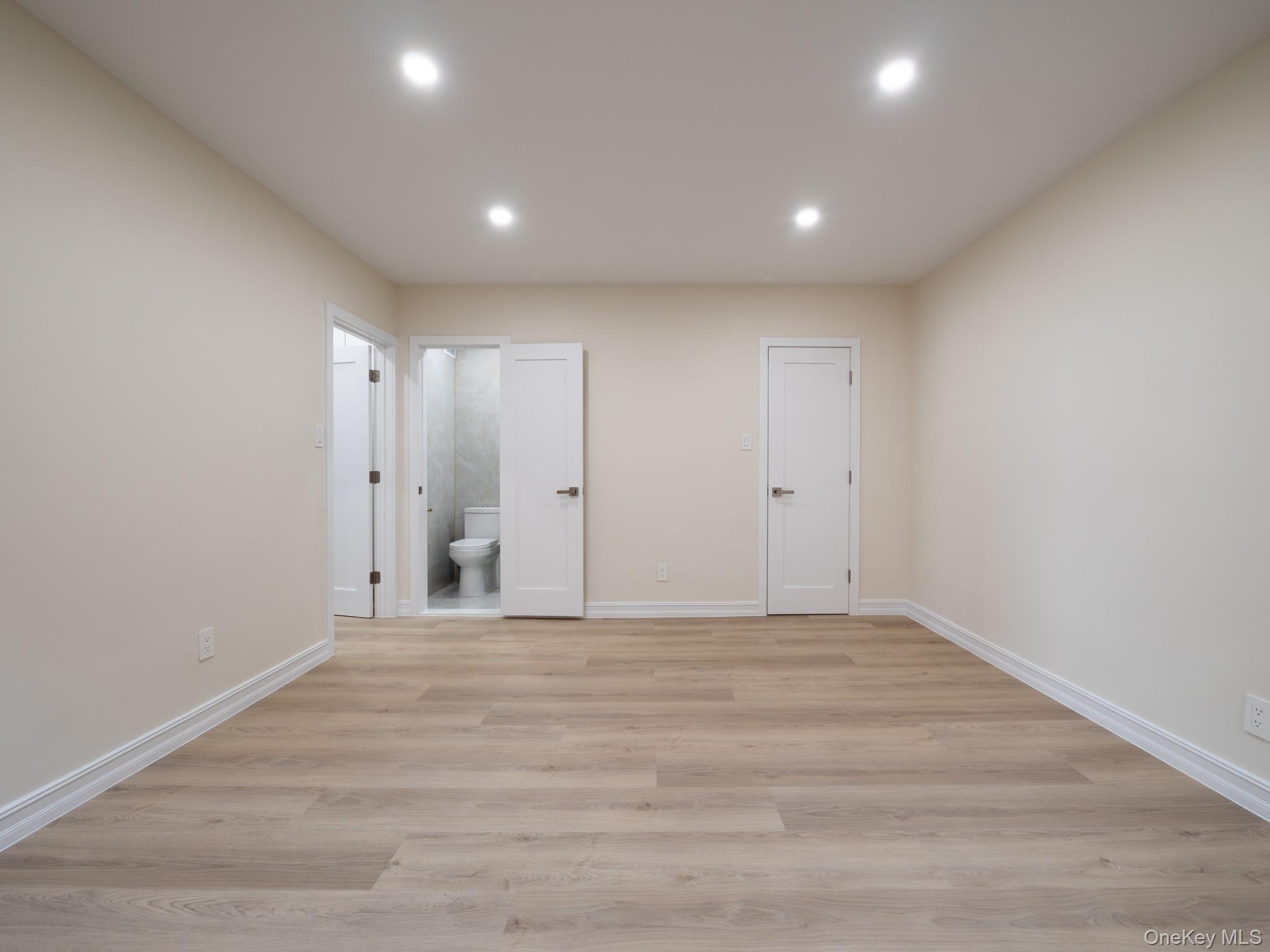 139-15 83rd Avenue, Unit 423 Queens, NY 11435 - Photo 15 of 24 Unfurnished bedroom with light wood-style floors, recessed lighting, and connected bathroom