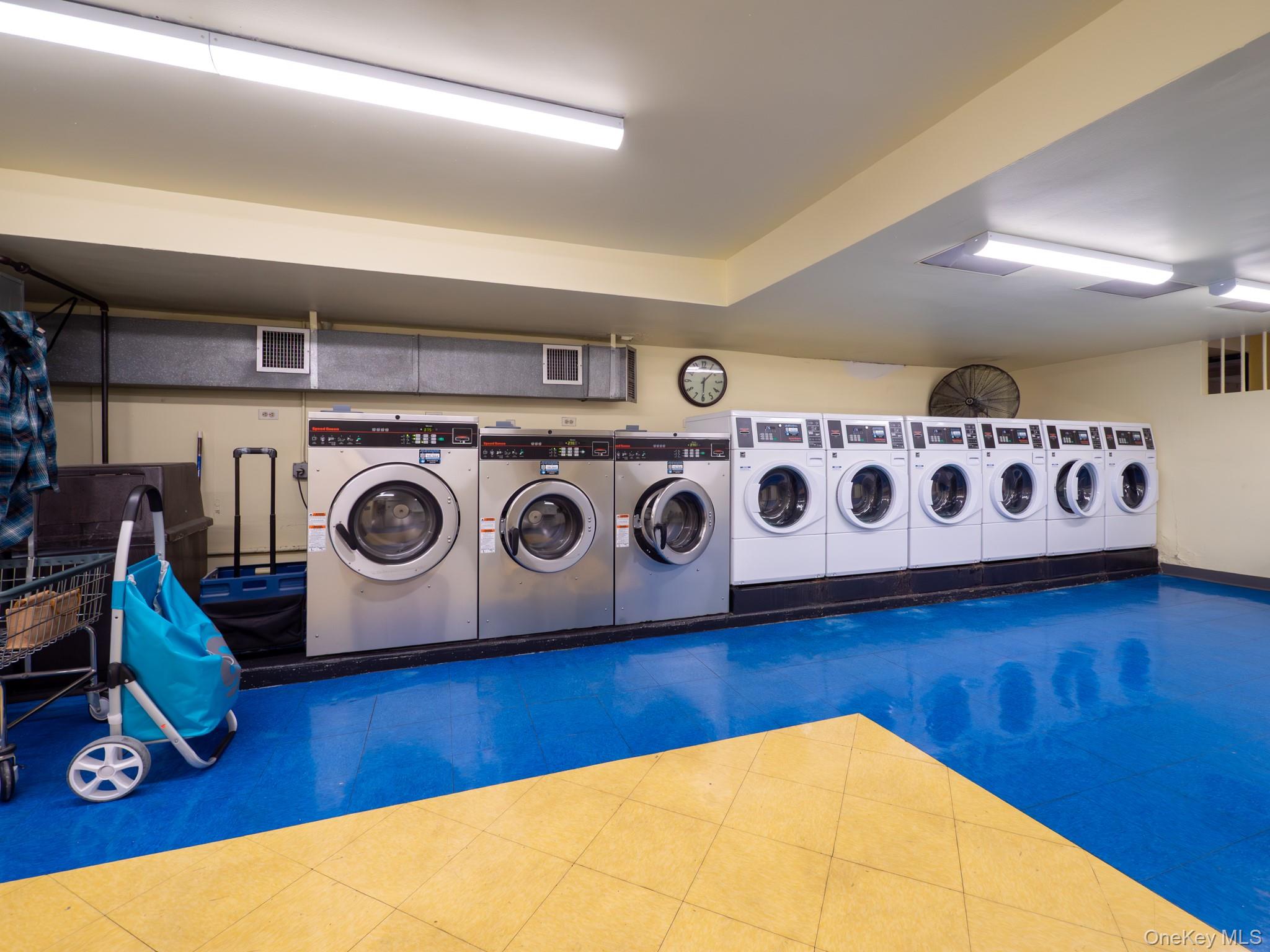 139-15 83rd Avenue, Unit 423 Queens, NY 11435 - Photo 22 of 24 Shared laundry featuring washing machine and dryer