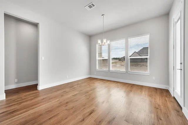a view of a kitchen with wooden floor and a kitchen