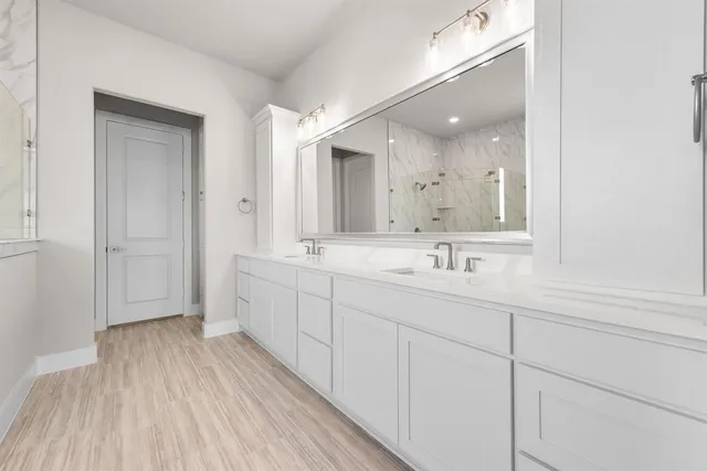 a bathroom with a sink vanity and mirror