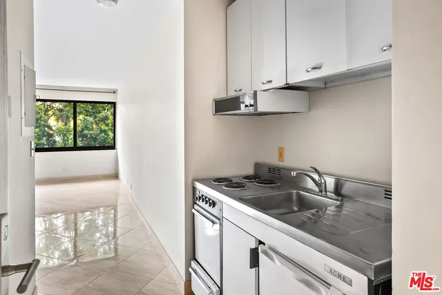 a kitchen with stainless steel appliances granite countertop a sink and a stove