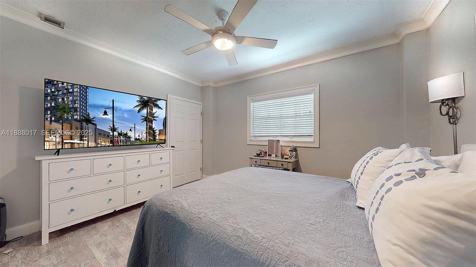 18475 Southwest 204th Street Miami, FL 33187 - Photo 13 of 41 a bedroom with a bed and a painting on the wall