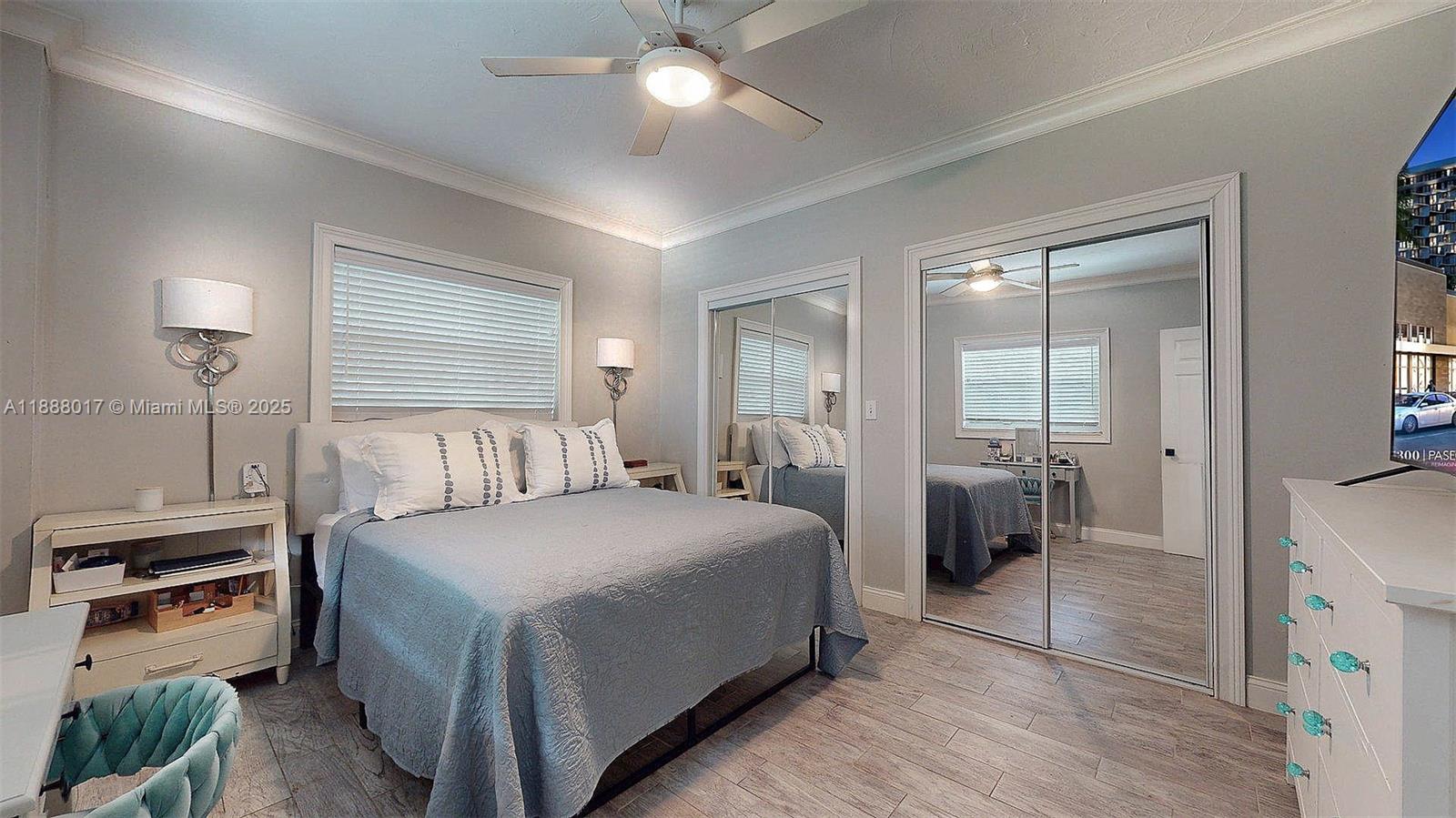 18475 Southwest 204th Street Miami, FL 33187 - Photo 14 of 41 a bedroom with a bed and a chandelier