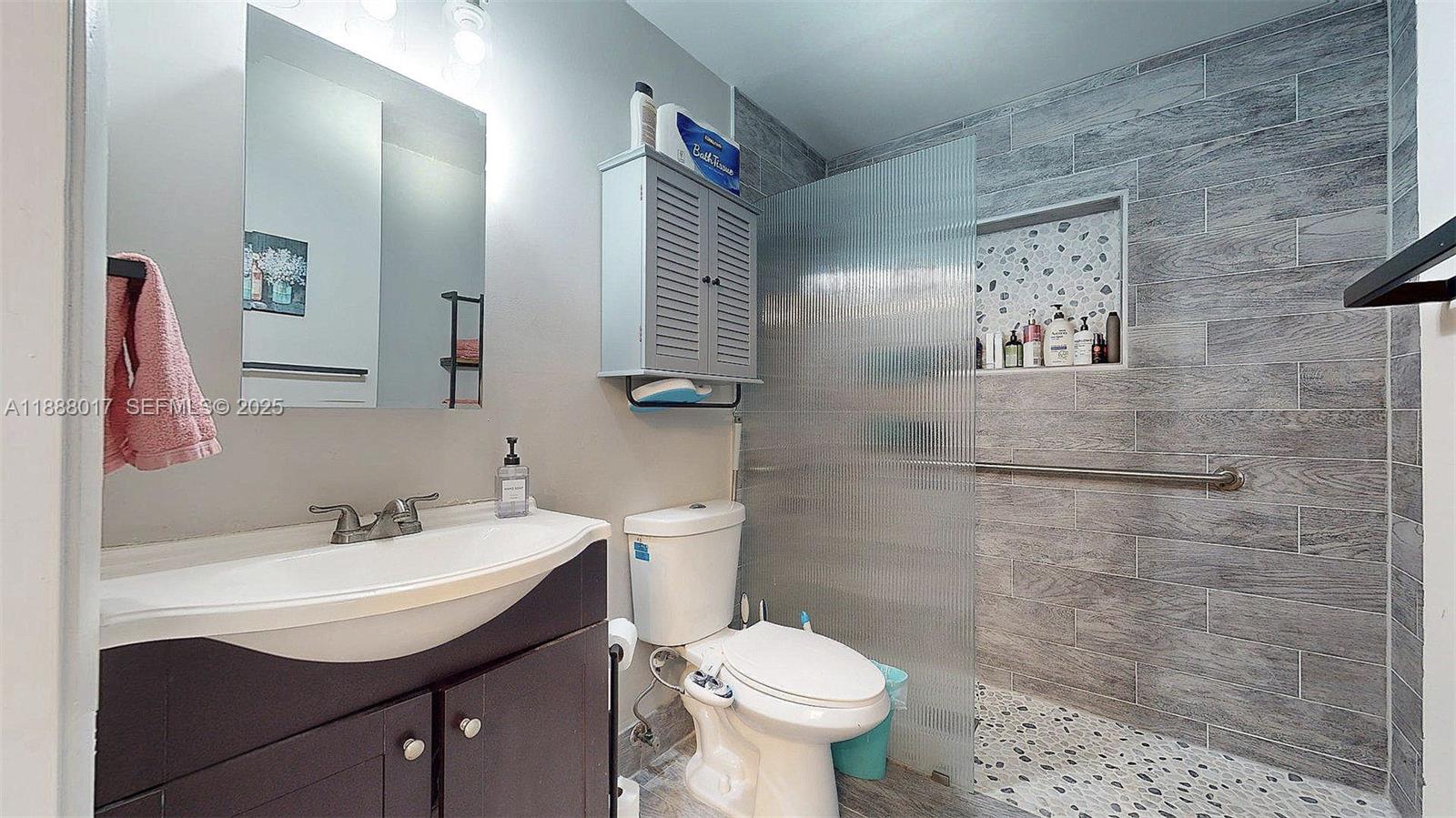 18475 Southwest 204th Street Miami, FL 33187 - Photo 16 of 41 a bathroom with a sink toilet and a mirror