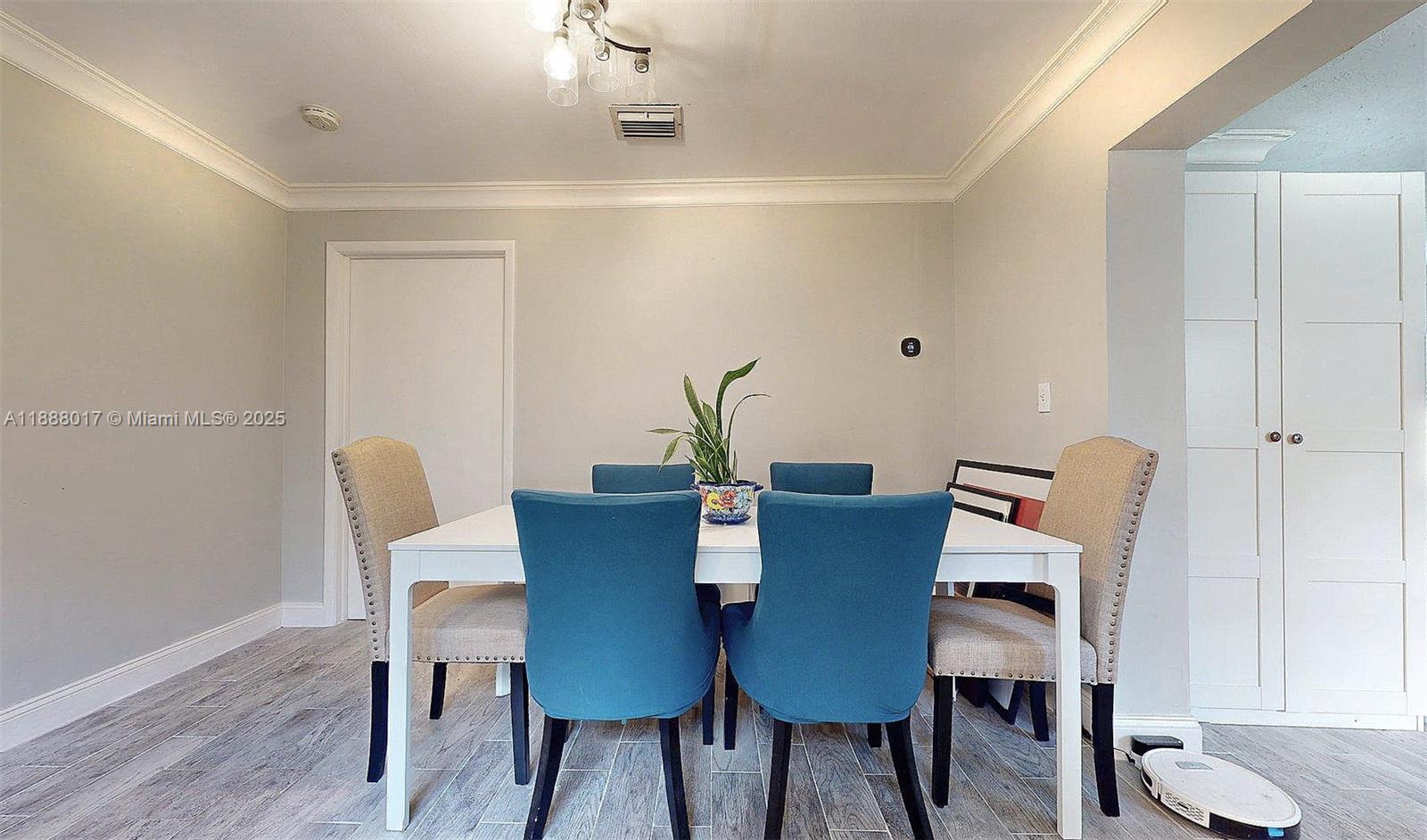 18475 Southwest 204th Street Miami, FL 33187 - Photo 17 of 41 a view of a dining room with furniture and wooden floor