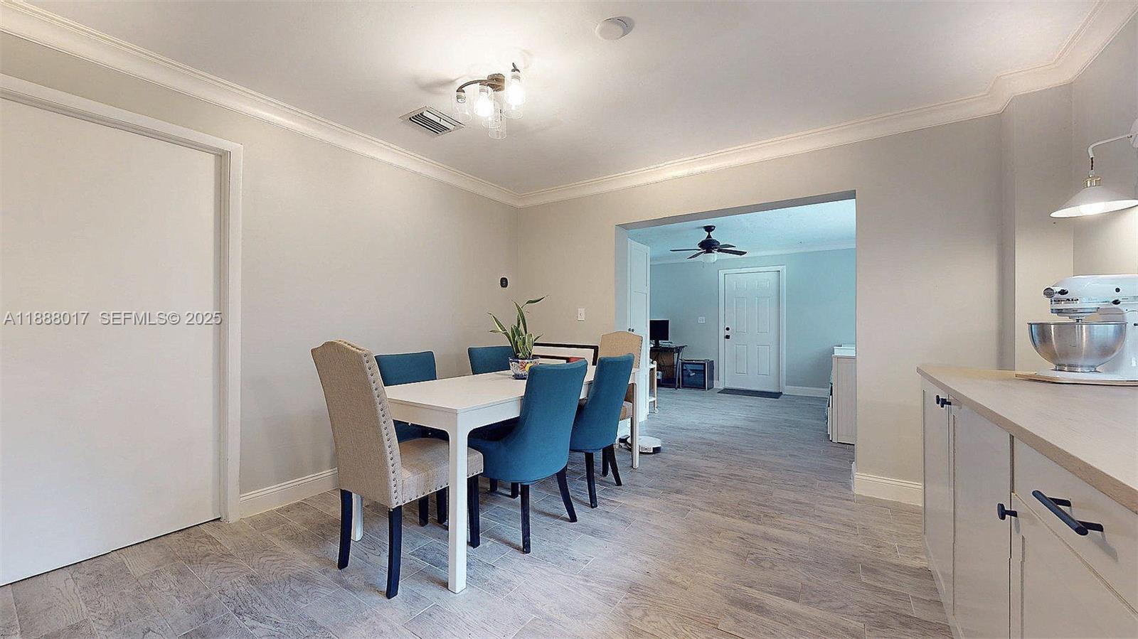 18475 Southwest 204th Street Miami, FL 33187 - Photo 18 of 41 a view of a dining room with furniture and wooden floor