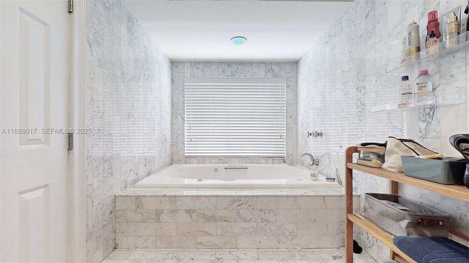 18475 Southwest 204th Street Miami, FL 33187 - Photo 24 of 41 a bath tub sitting in a bathroom next to a sink