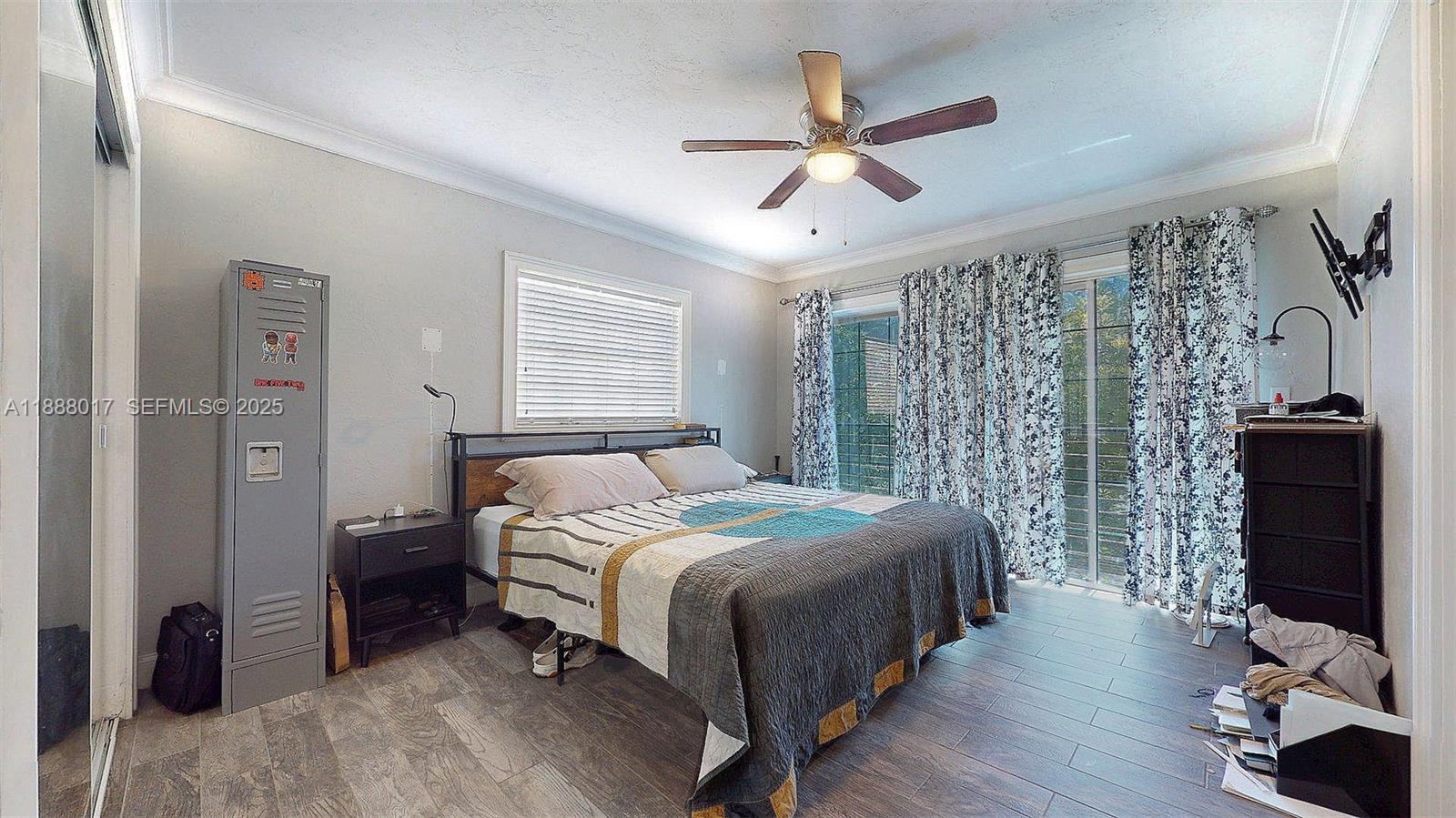 18475 Southwest 204th Street Miami, FL 33187 - Photo 27 of 41 a bedroom with a bed and a flat screen tv