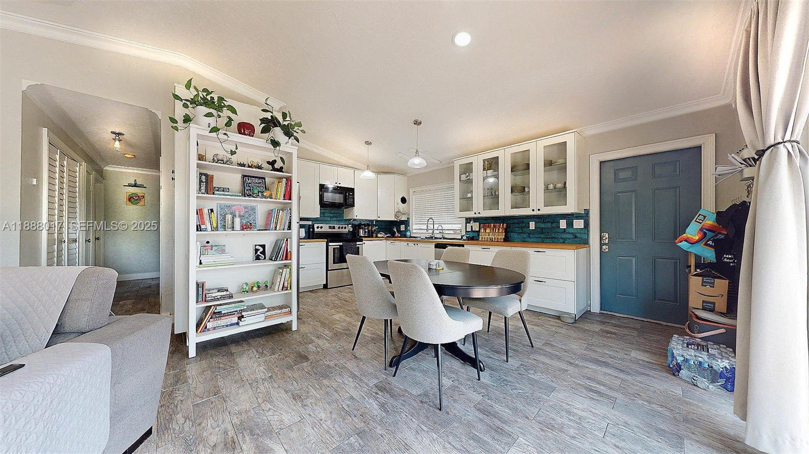 18475 Southwest 204th Street Miami, FL 33187 - Photo 29 of 41 a living room with furniture and a kitchen view