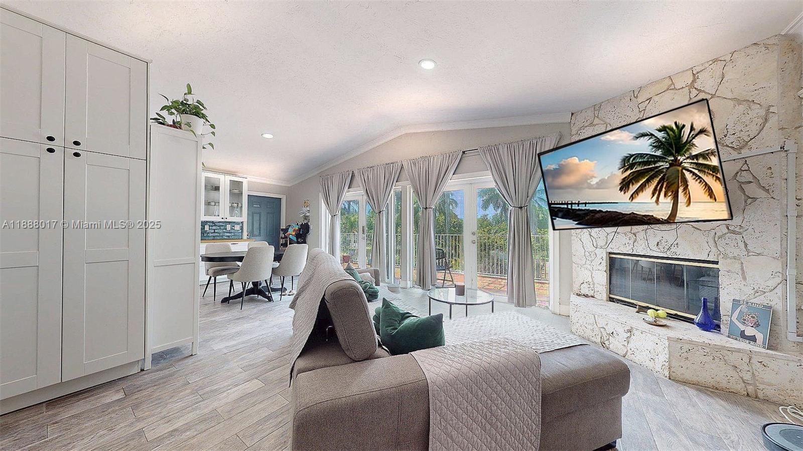 18475 Southwest 204th Street Miami, FL 33187 - Photo 30 of 41 a living room with furniture a fireplace and a flat screen tv