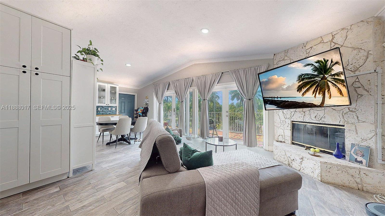 18475 Southwest 204th Street Miami, FL 33187 - Photo 30 of 41 a living room with furniture a fireplace and a flat screen tv