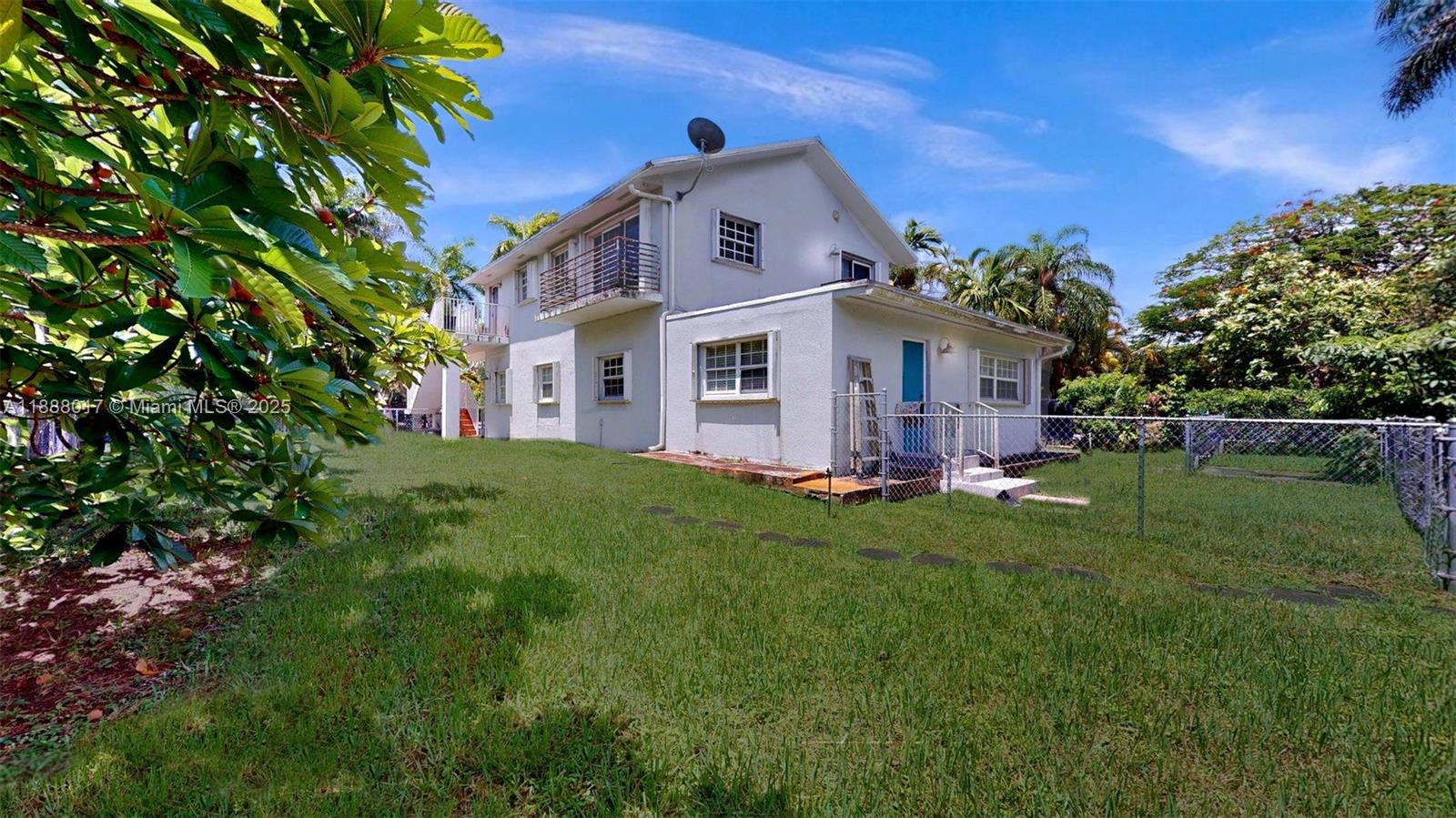 18475 Southwest 204th Street Miami, FL 33187 - Photo 32 of 41 a front view of house with yard and green space