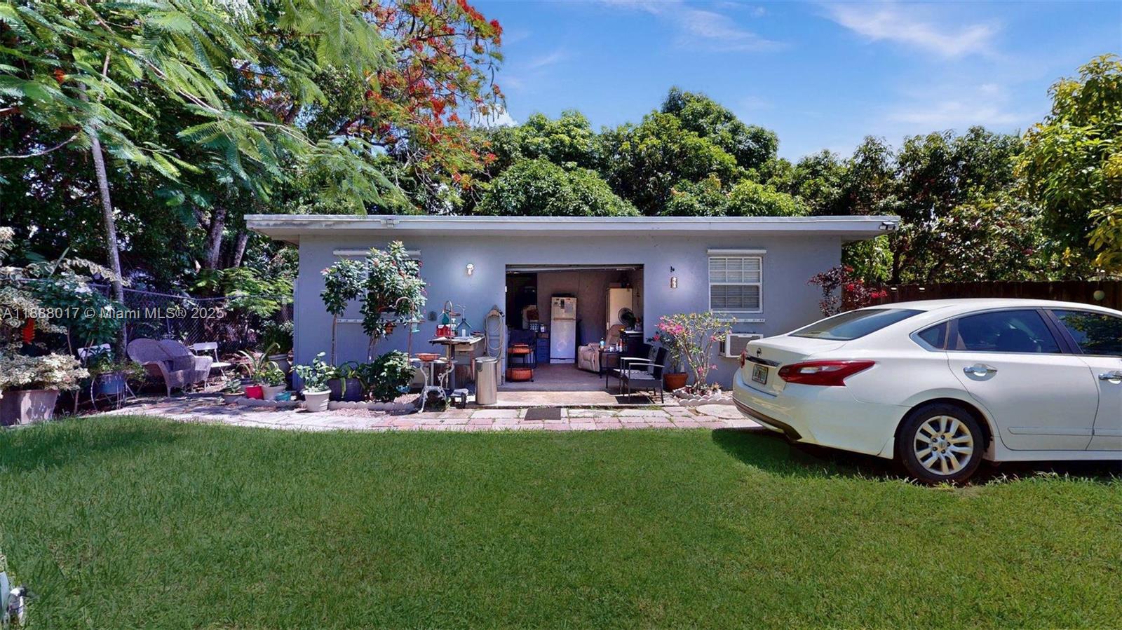 18475 Southwest 204th Street Miami, FL 33187 - Photo 33 of 41 a front view of a house with garden
