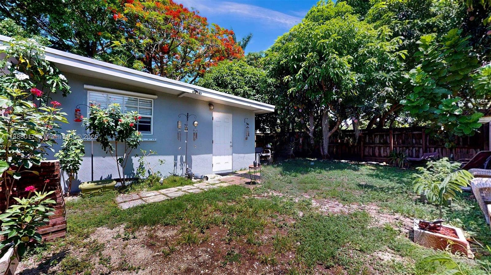 18475 Southwest 204th Street Miami, FL 33187 - Photo 34 of 41 a view of a house with a yard and plants