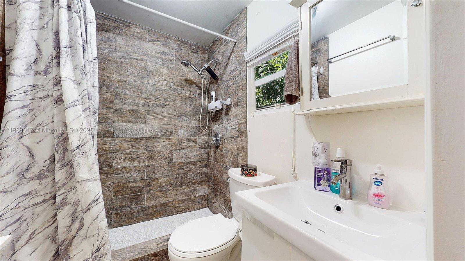 18475 Southwest 204th Street Miami, FL 33187 - Photo 35 of 41 a bathroom with a sink toilet and shower