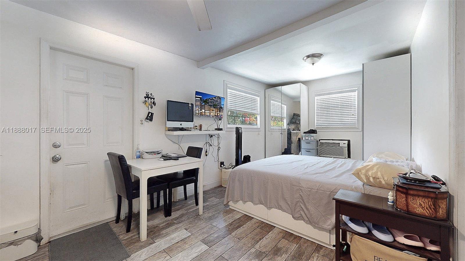 18475 Southwest 204th Street Miami, FL 33187 - Photo 37 of 41 a bedroom with a bed and a table in it