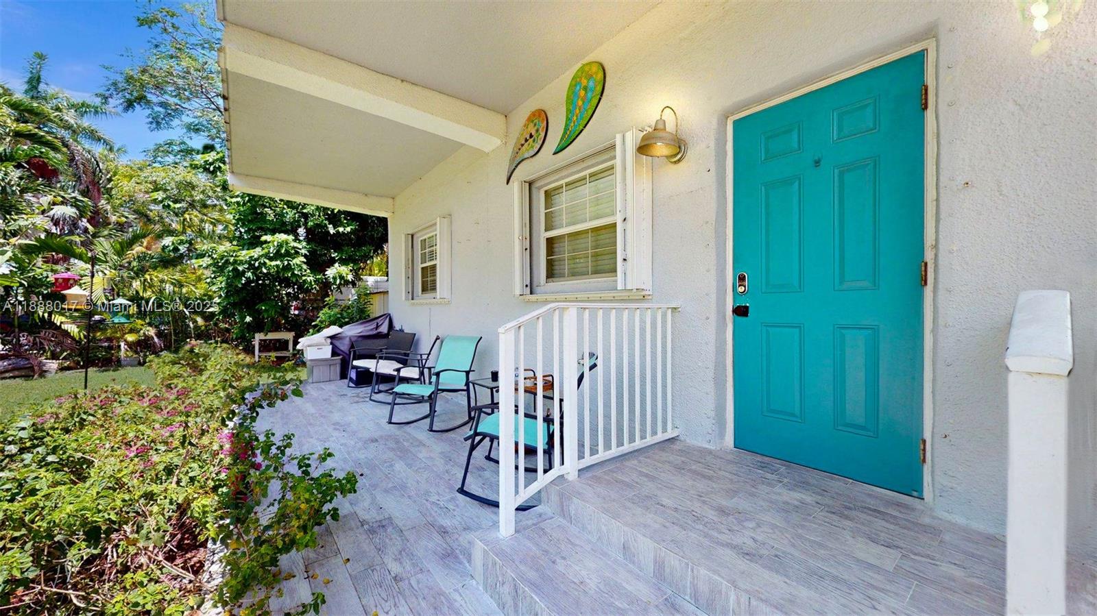 18475 Southwest 204th Street Miami, FL 33187 - Photo 6 of 41 a view of a porch with chairs and potted plants