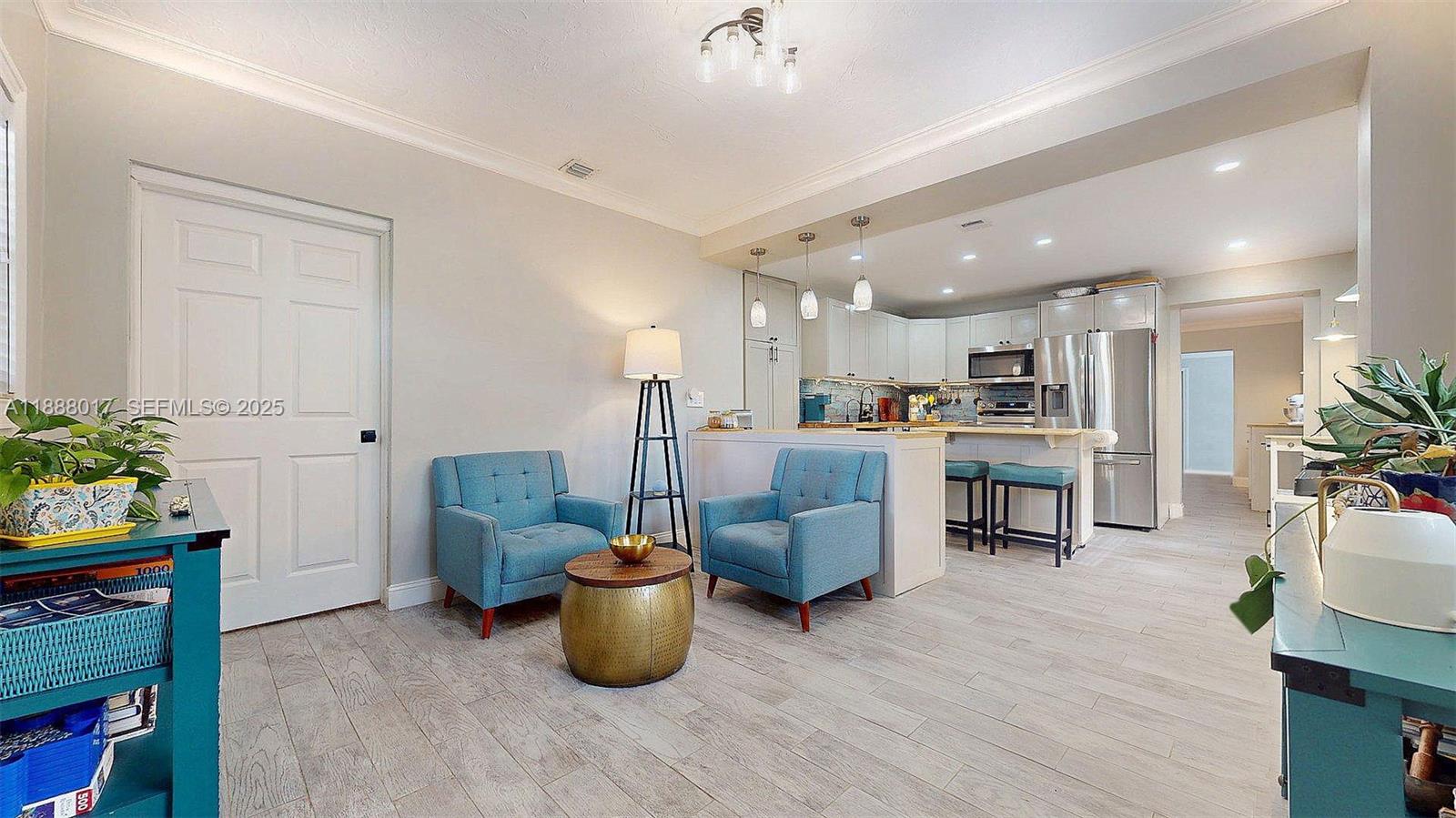 18475 Southwest 204th Street Miami, FL 33187 - Photo 8 of 41 a living room with furniture a potted plant and kitchen view