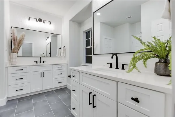 a bathroom with a double vanity sink and mirror