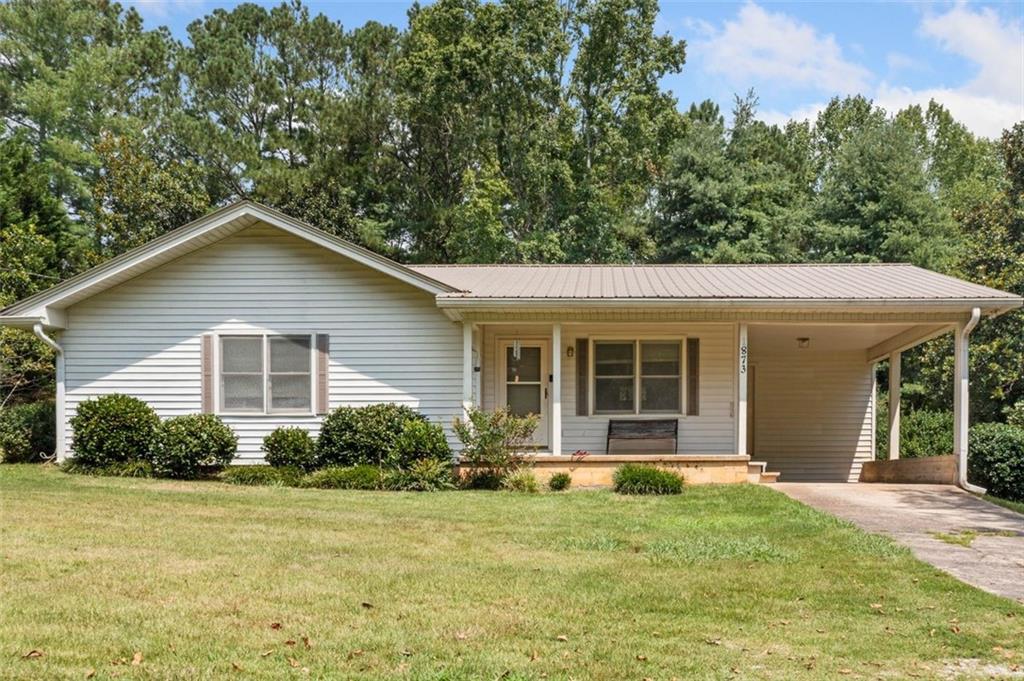 a front view of a house with garden