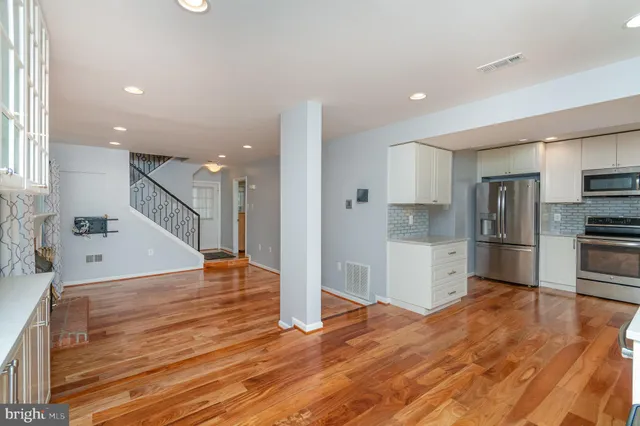 a white house that has a tree in front of it