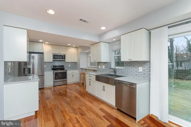 a kitchen with stainless steel appliances a refrigerator and a stove top oven
