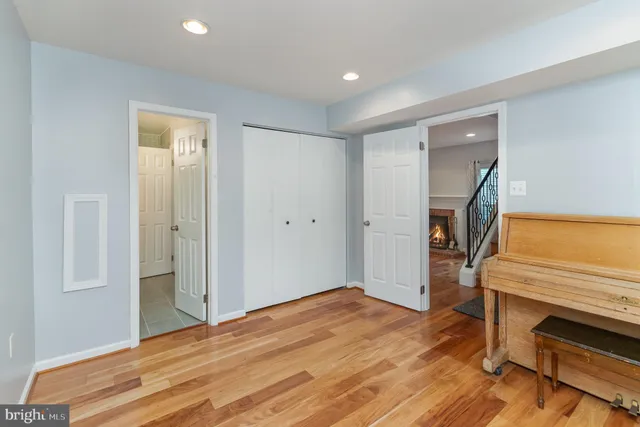 a kitchen with granite countertop wooden floors and white cabinets