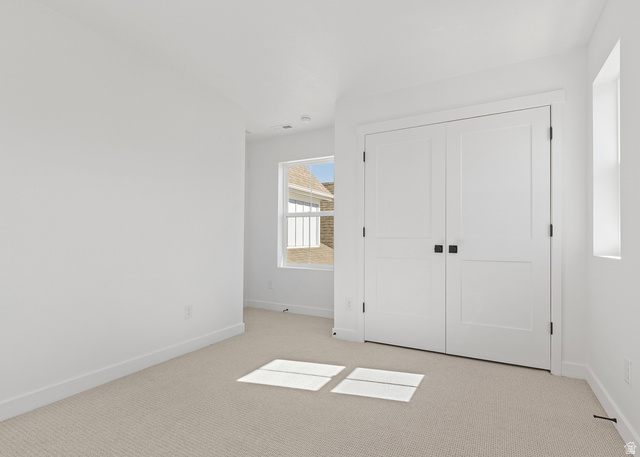 11214 South Easy Bee Road, Unit 270 South Jordan, UT 84009 - Photo 21 of 31 Interior room featuring light-toned carpet flooring, white walls, and bright white trim