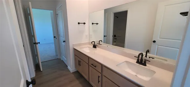 a bathroom with a double vanity sink double and a mirror