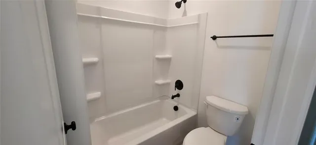 a bathroom with a toilet and a bathtub