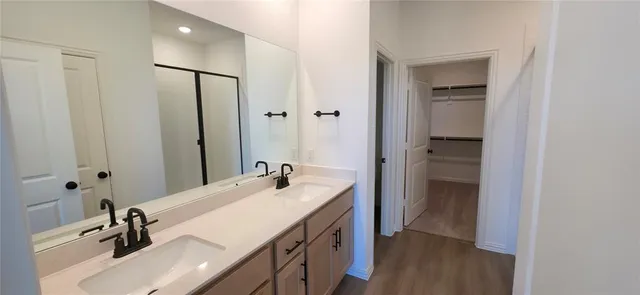 a bathroom with a sink double vanity and a mirror