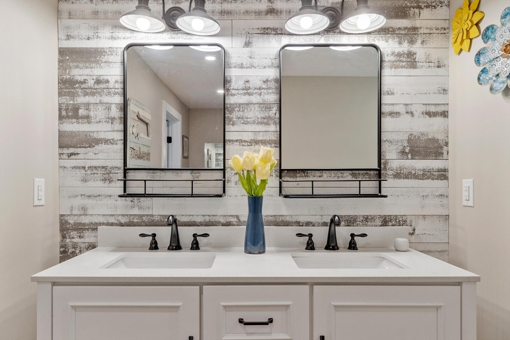 241 Reservoir Road Lunenburg, MA 01462 - Photo 30 of 40 a bathroom with a sink and a mirror