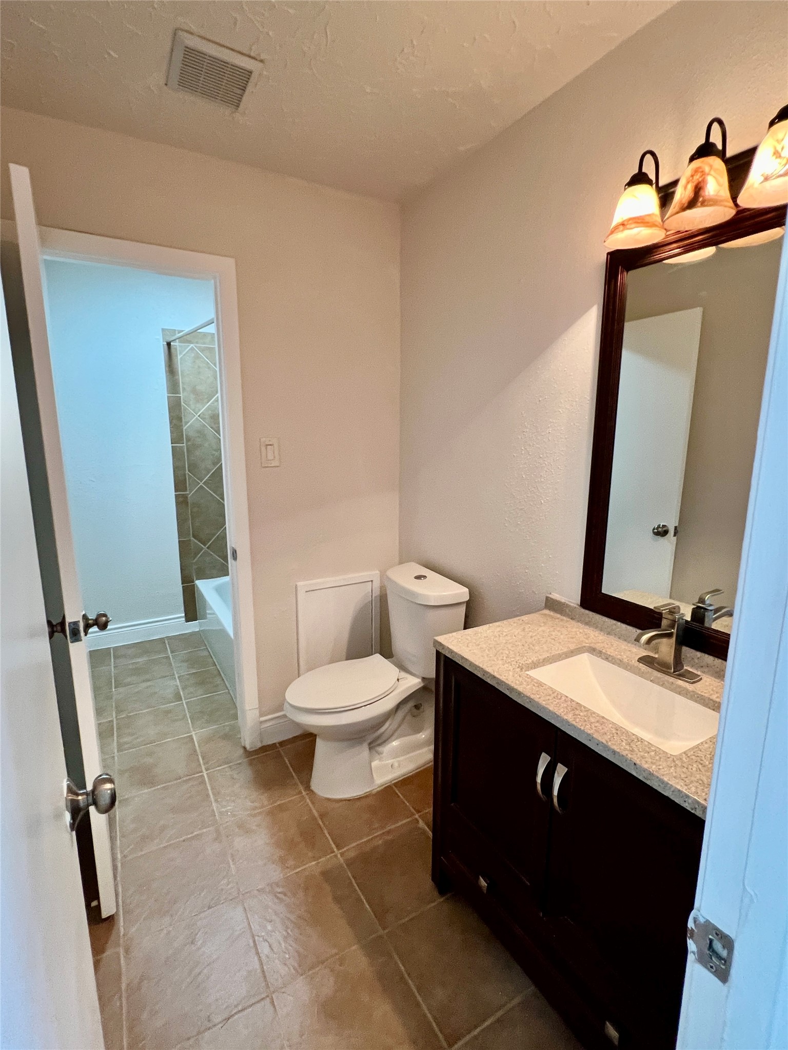 12110 Murr Way Houston, TX 77048 - Photo 10 of 24 a bathroom with a granite countertop sink toilet and mirror