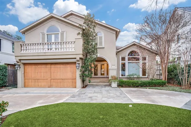 a view of front a house with a yard and garage