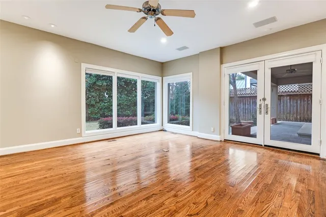 a view of an empty room with glass door and balcony