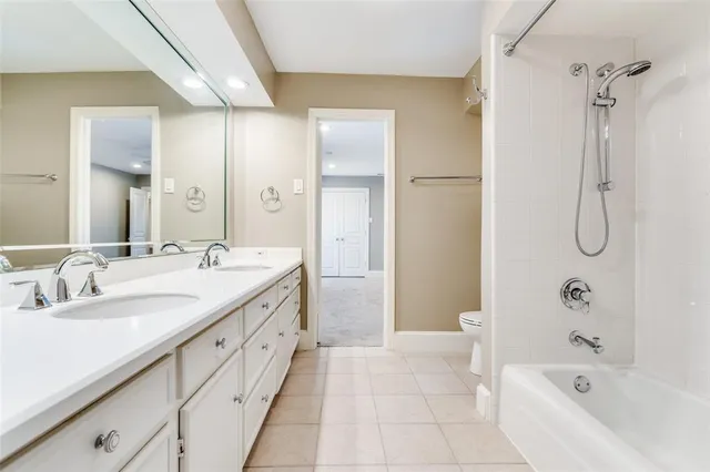 a spacious bathroom with a tub sink shower and mirror