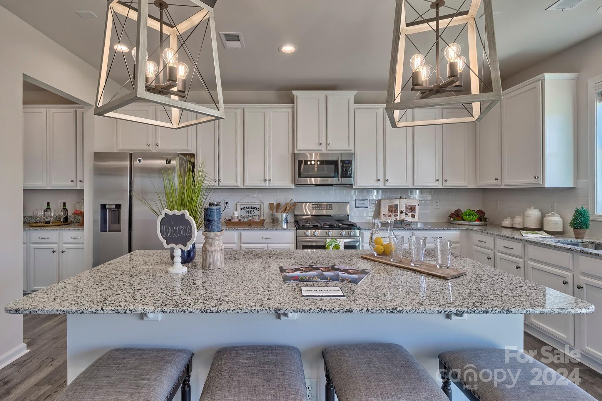 6504 Alanbrook Road, Unit 63 Charlotte, NC 28215 - Photo 11 of 25 a kitchen with stainless steel appliances granite countertop a sink a stove top oven a counter space and cabinets