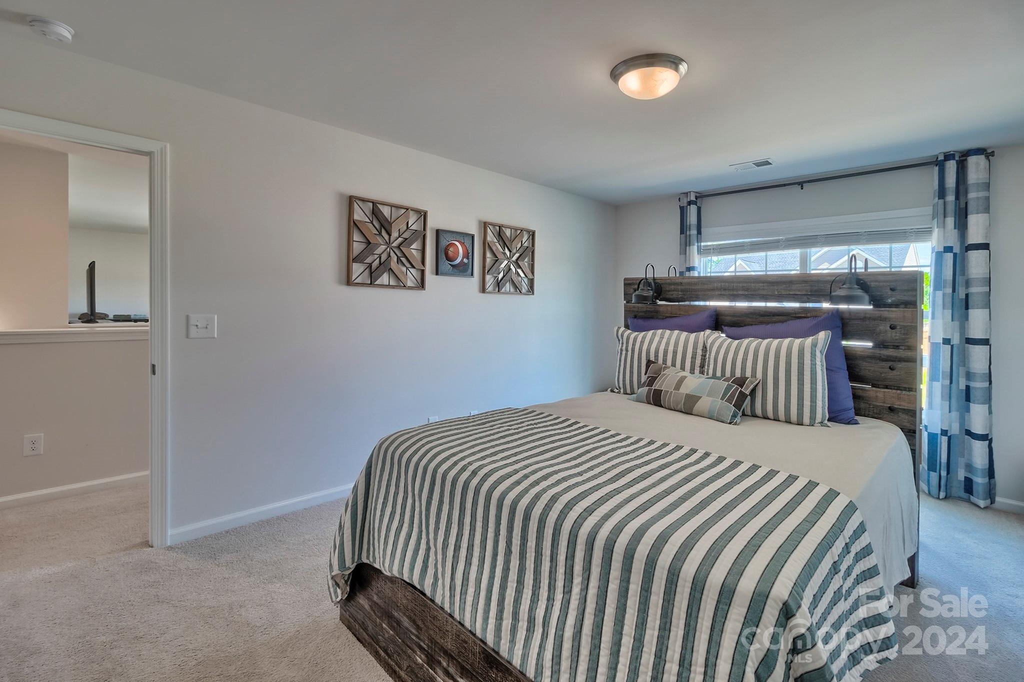 6504 Alanbrook Road, Unit 63 Charlotte, NC 28215 - Photo 15 of 25 a bedroom with a bed and window