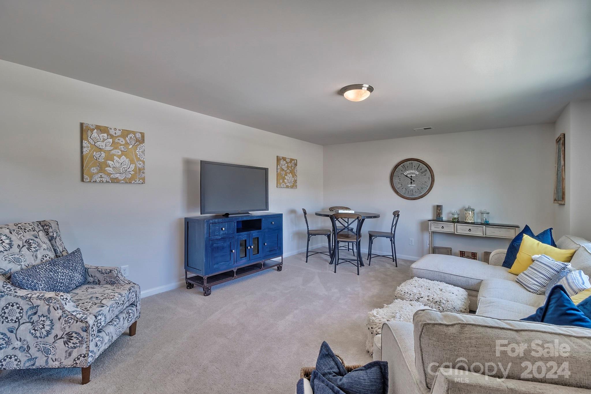 6504 Alanbrook Road, Unit 63 Charlotte, NC 28215 - Photo 21 of 25 a living room with furniture and a flat screen tv