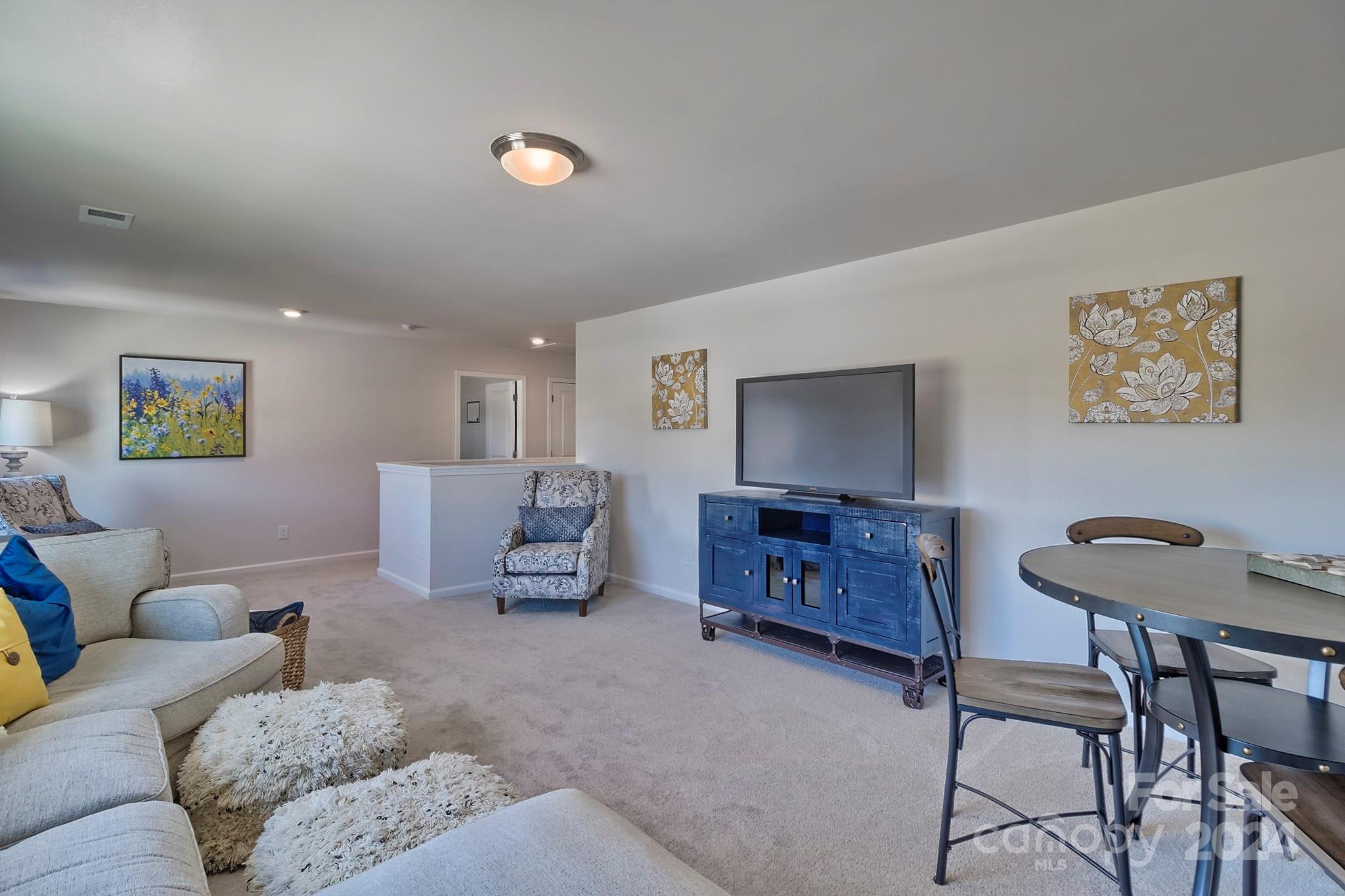 6504 Alanbrook Road, Unit 63 Charlotte, NC 28215 - Photo 22 of 25 a living room with furniture and a flat screen tv
