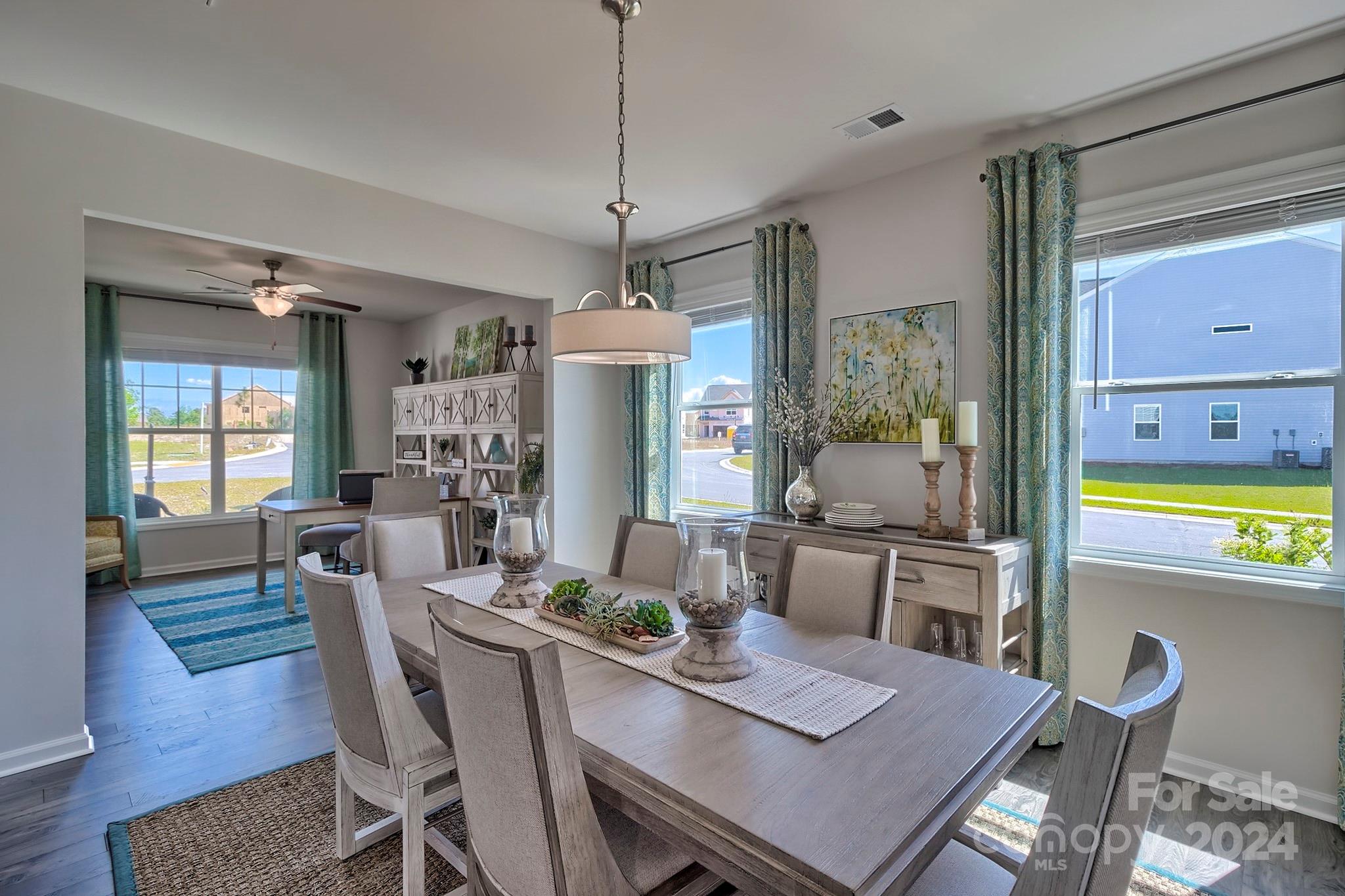6504 Alanbrook Road, Unit 63 Charlotte, NC 28215 - Photo 6 of 25 a view of a dining room with furniture window and wooden floor