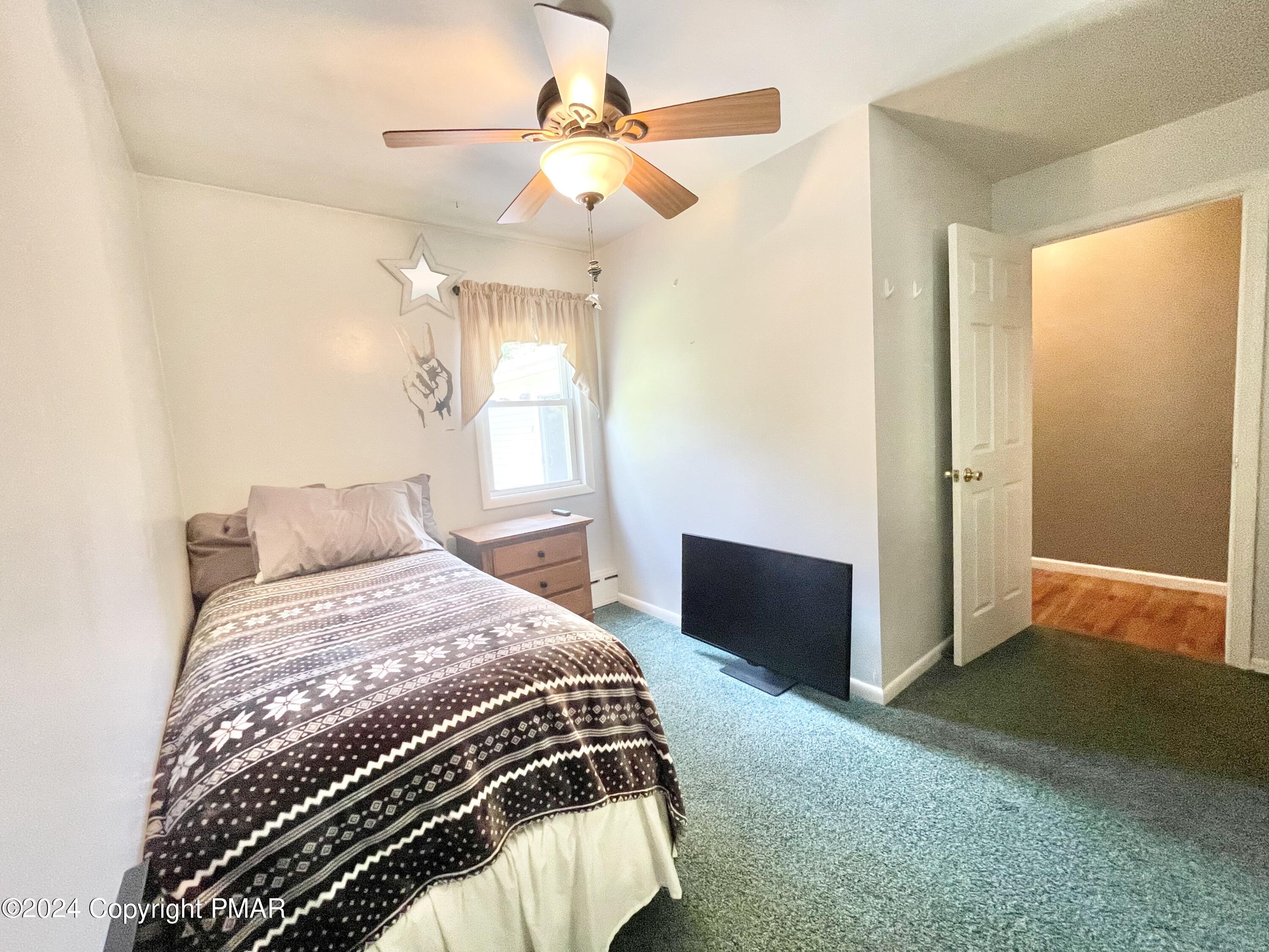 214 Shine Hill Road Henryville, PA 18332 - Photo 103 of 126 a bedroom with a bed and a chandelier