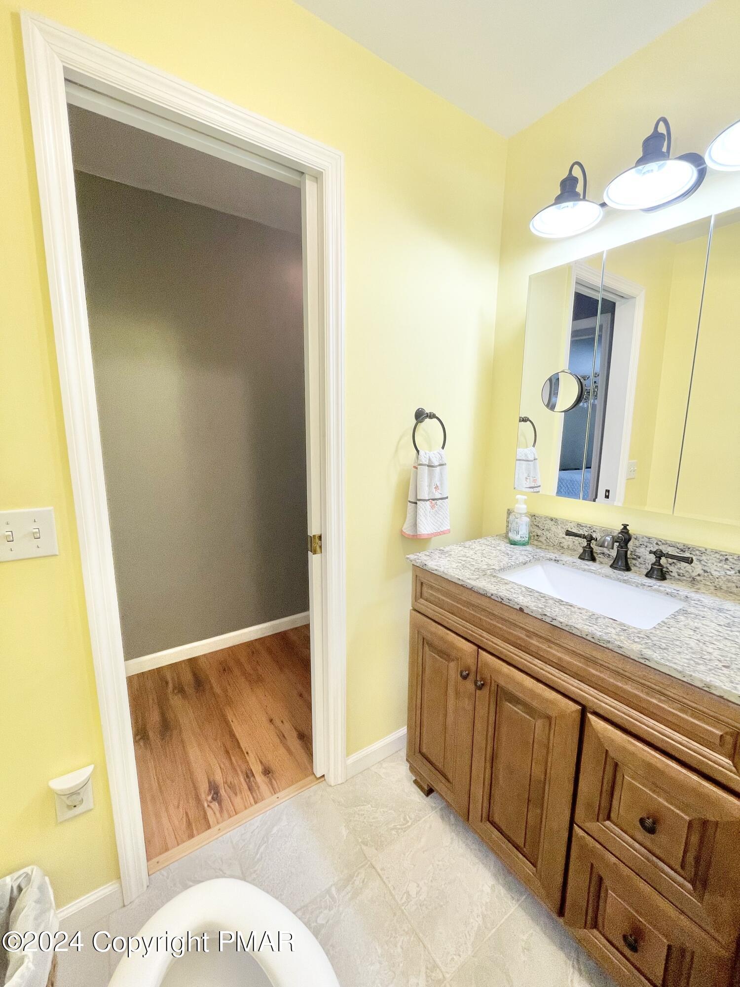 214 Shine Hill Road Henryville, PA 18332 - Photo 106 of 126 a bathroom with a granite countertop sink and a mirror
