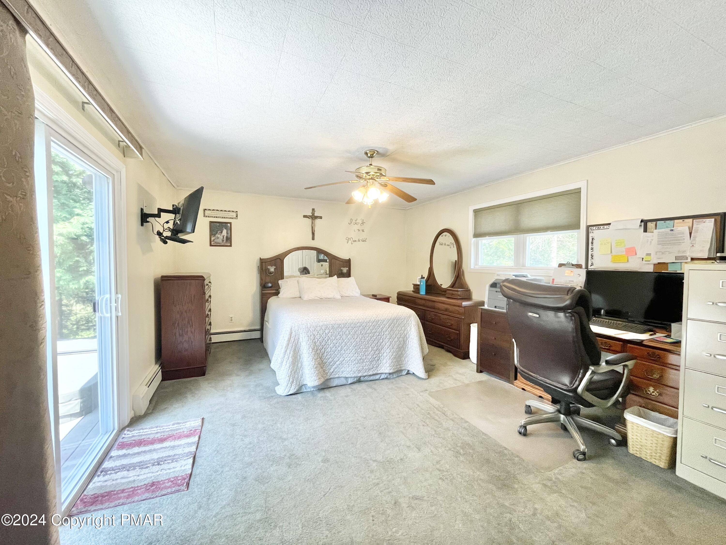 214 Shine Hill Road Henryville, PA 18332 - Photo 107 of 126 a bedroom with a bed and a chandelier